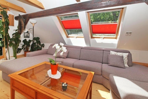 red VELUX blinds fitted on VELUX pitched roof windows